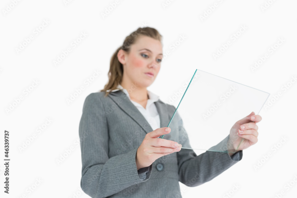 Blonde businesswoman viewing glass pane Blonde businesswoman viewing glass pane