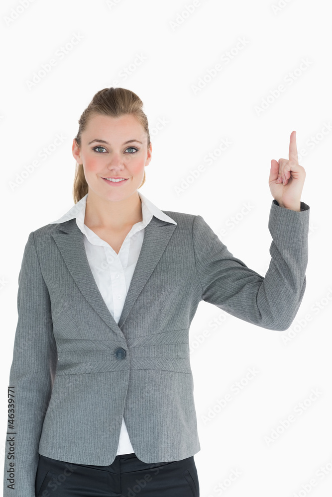 Smiling businesswoman pointing up in the air Smiling businesswoman pointing up in the air