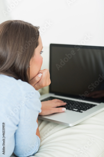 Brunette woman typing on the laptop