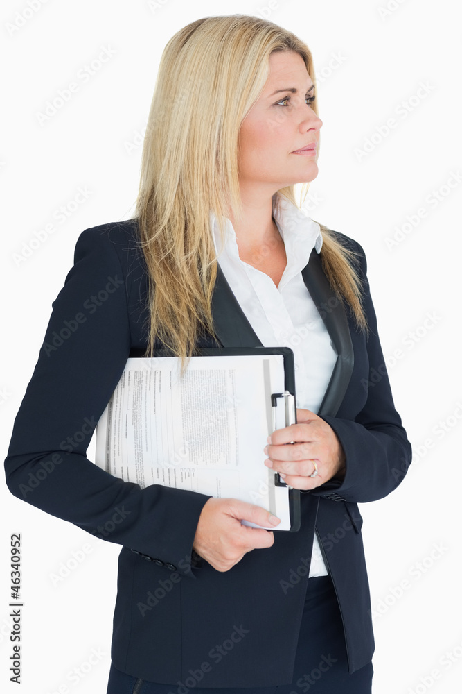 Business woman looking away with a clipboard Business woman looking away with a clipboard