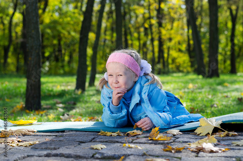 Mischievous small girl in a park photo