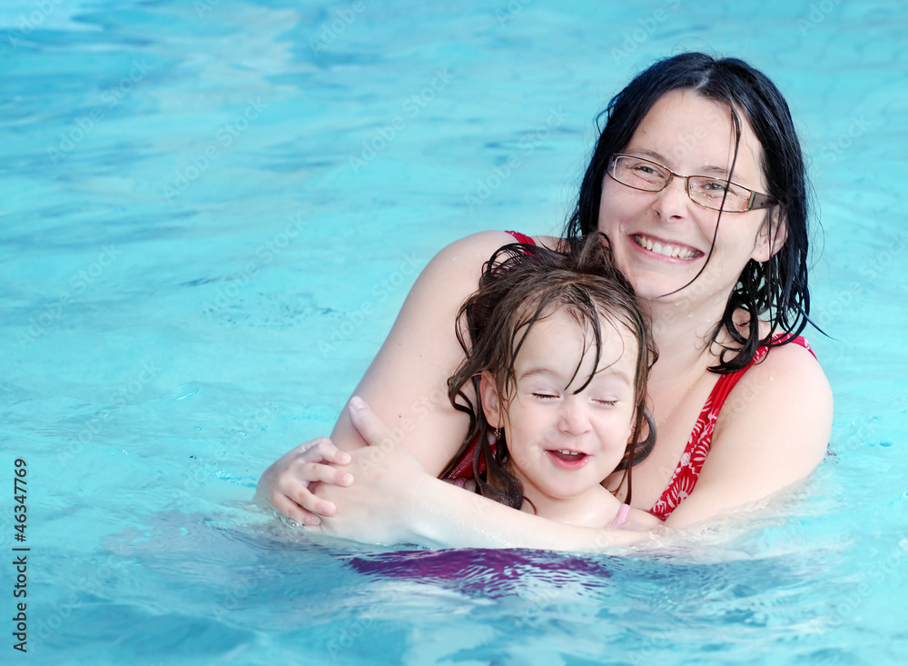 Happy family playing in a swimming pool. Happy family playing in a swimming pool.