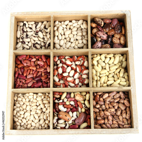 Diverse beans in wooden box sections isolated on white