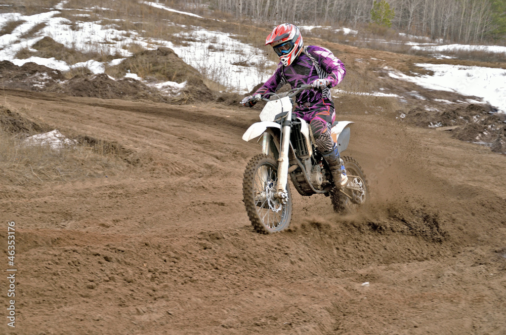 Obraz premium Motocross rider on a motorcycle rides cornering