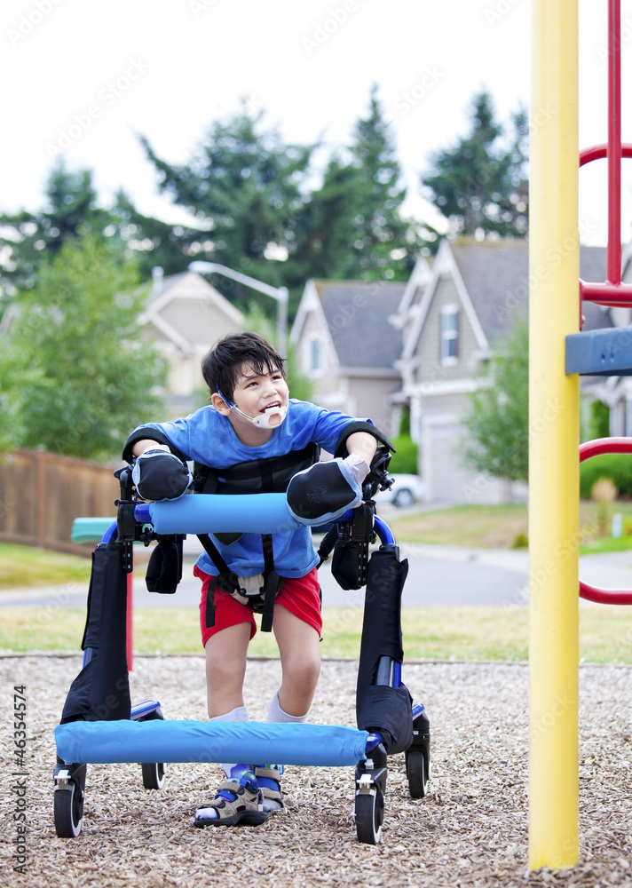 Obraz premium Disabled boy in walker walking up to playground
