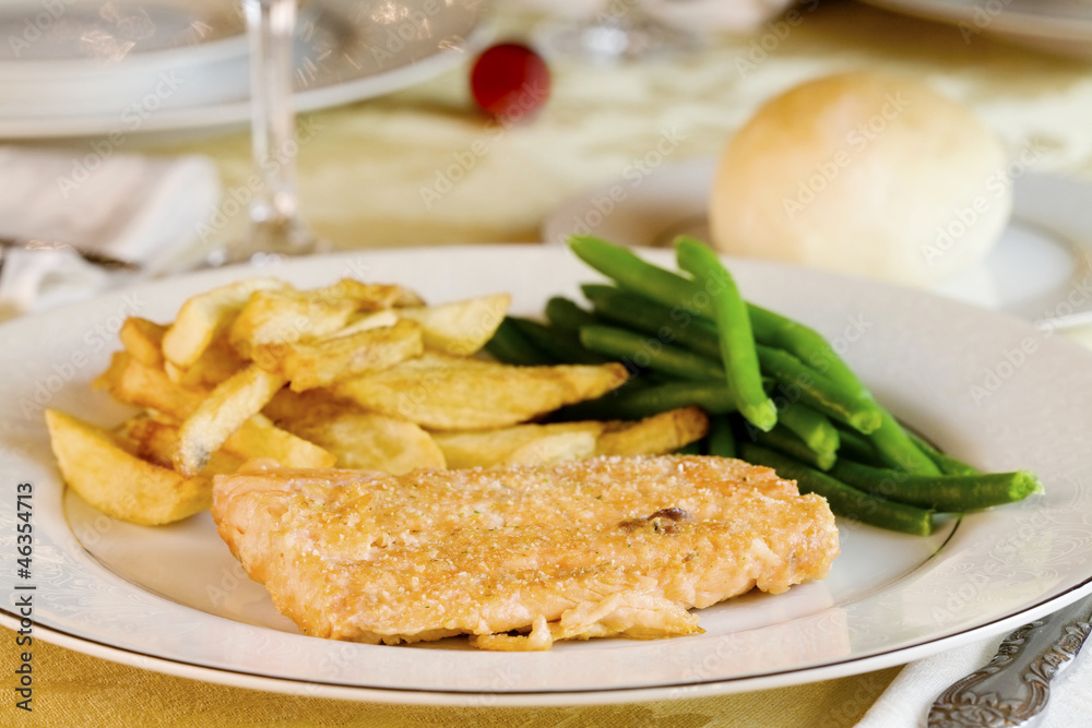 Plate of delicious fried salmon with  pototoes and green beans.