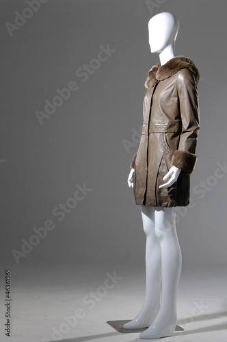 female fashion coat on mannequin a gray background