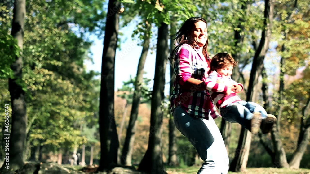 Young mother having fun with her son in beautiful autumn park, s Young mother having fun with her son in beautiful autumn park, s