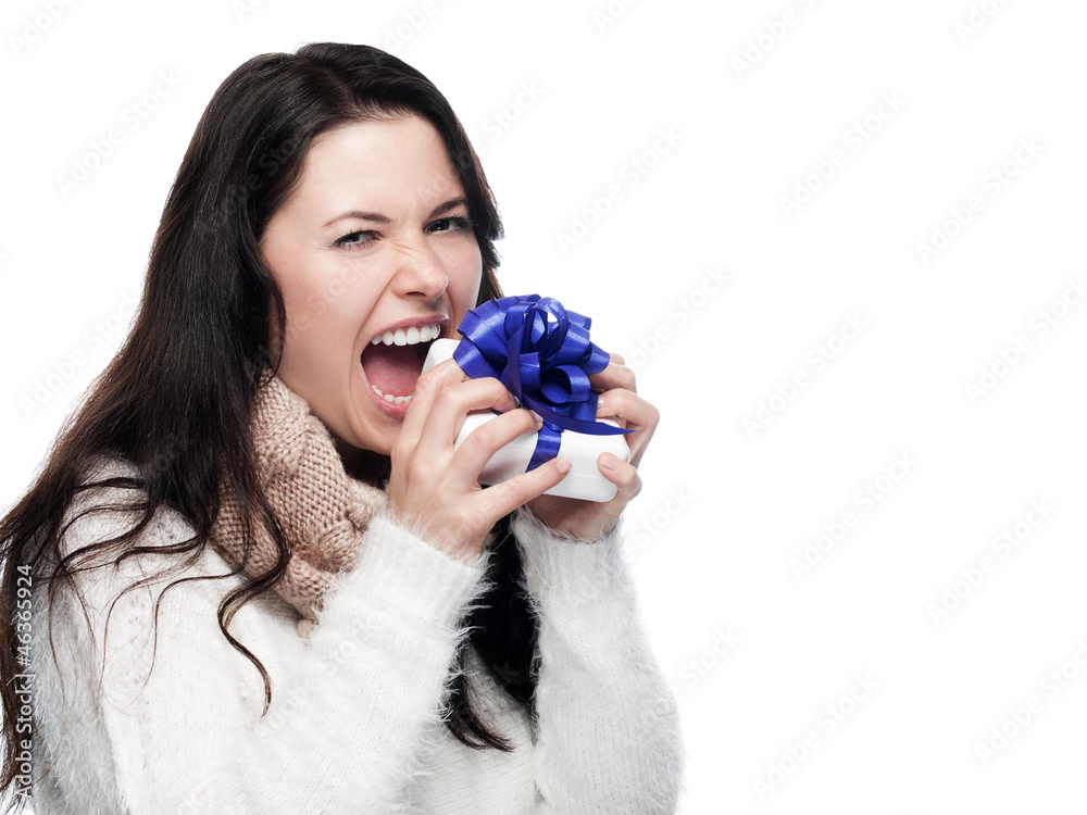 Young woman biting into a gift - isolated Young woman biting into a gift - isolated