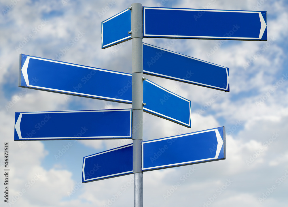 Blank blue direction sign with 8 arrows isolated on sky Blank blue direction sign with 8 arrows isolated on sky