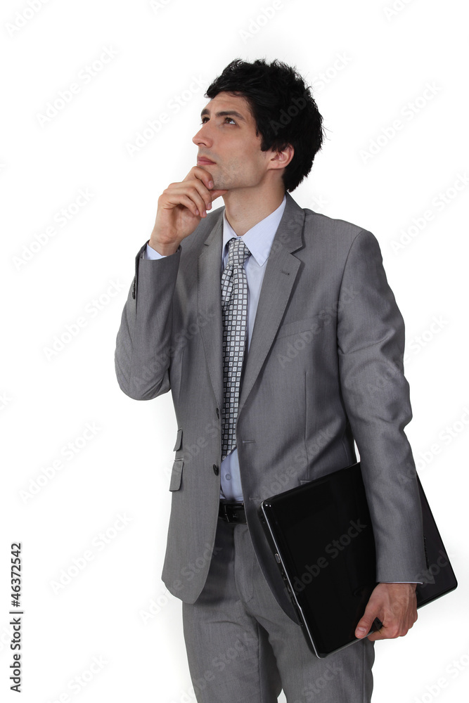 Pensive businessman rubbing his chin Pensive businessman rubbing his chin