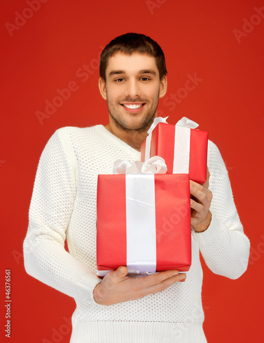man holding many gift boxes © Syda Productions