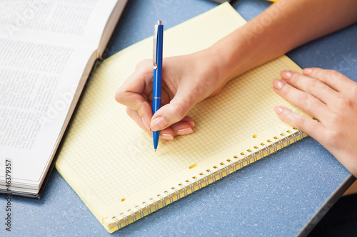 Woman writing in a note pad