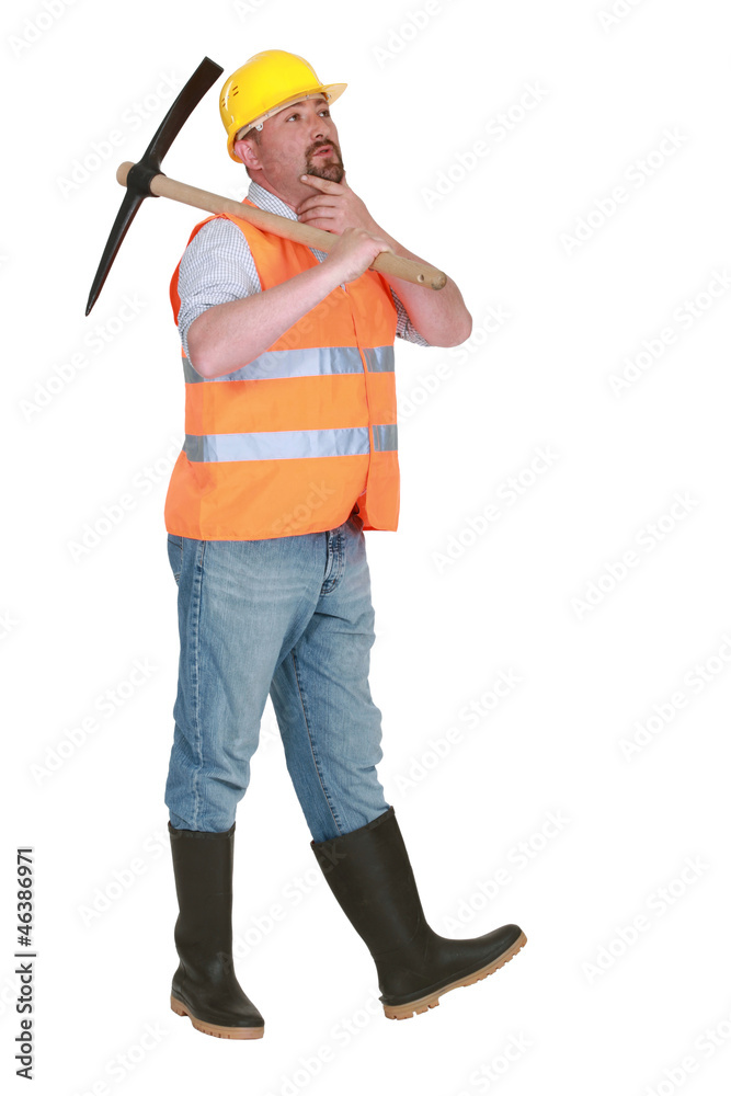 Contemplative labourer holding a pickaxe Contemplative labourer holding a pickaxe
