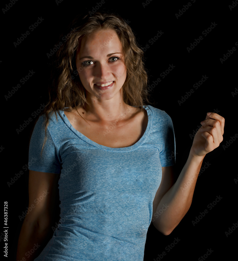 A beautiful young woman smiling isolated on a black background. A beautiful young woman smiling isolated on a black background.
