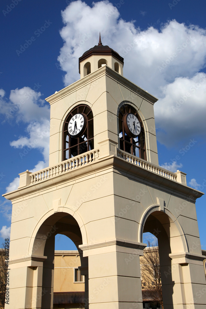 Modern clock tower structure against blue sky