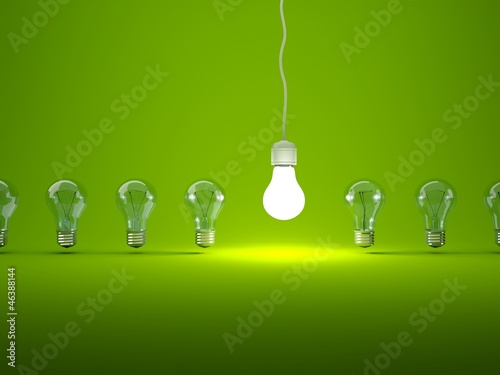 Row of light bulbs on green background