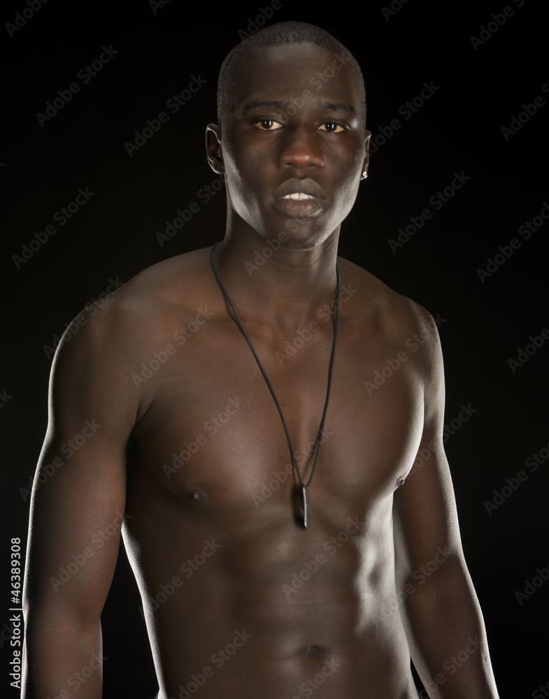 Fototapeta premium Young black man isolated on black