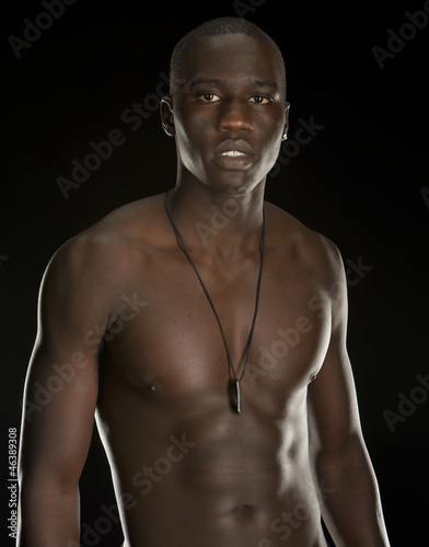 Young black man isolated on black