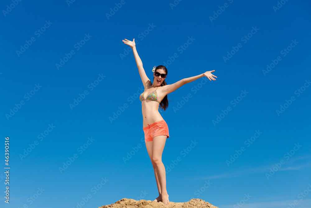 Portrait of young woman in bikini at beach