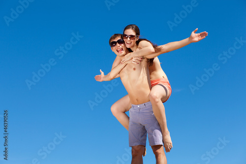 Happy Young Couple Together On The Beach © Sergey Nivens
