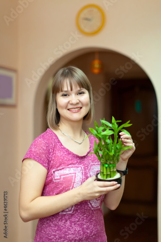 Girl with lucky bamboo plant photo