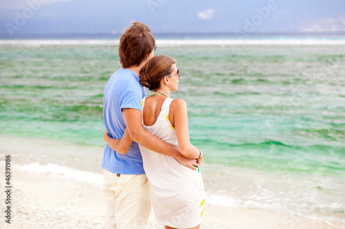 beautiful young couple looking on the horizon. honeymoom