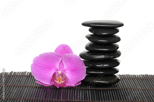 Stone tower with macro of orchid on mat