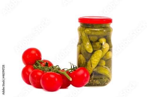 preserved cucumbers jar and fresh tomato bunch