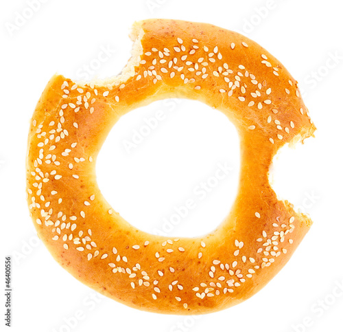 Bitten bagel with sesame seeds isolated on white