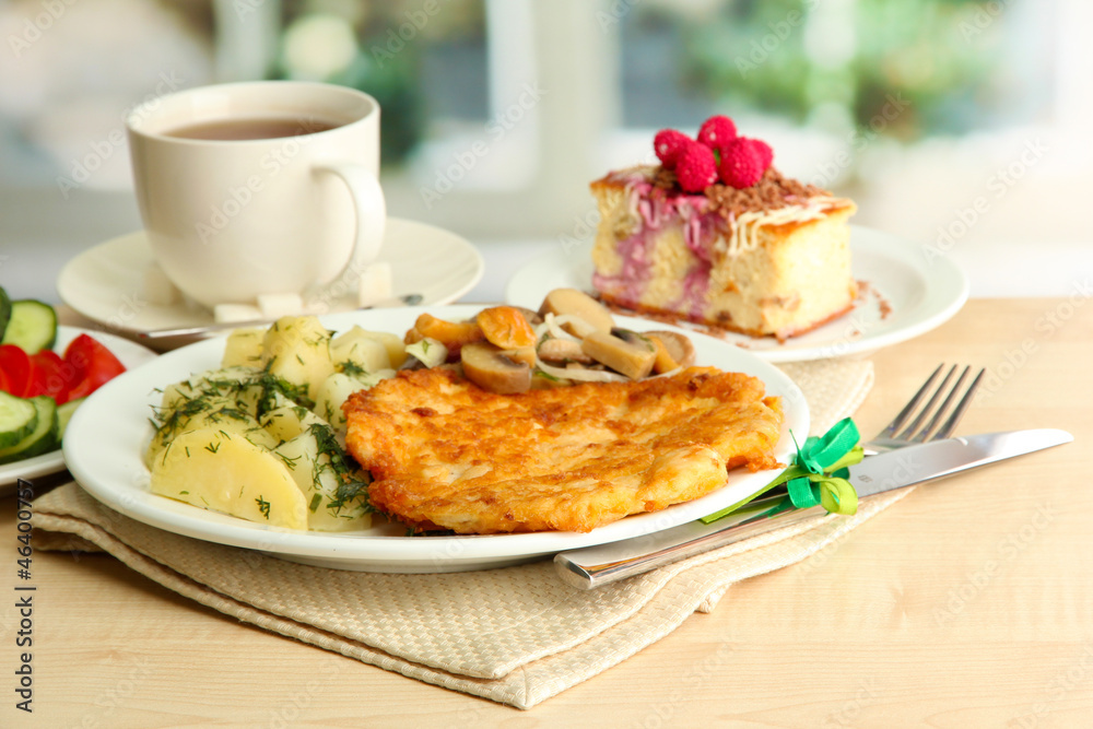 Roast chicken cutlet with boiled potatoes  cup of tea and