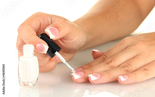 Woman makes herself a French manicure  on white background
