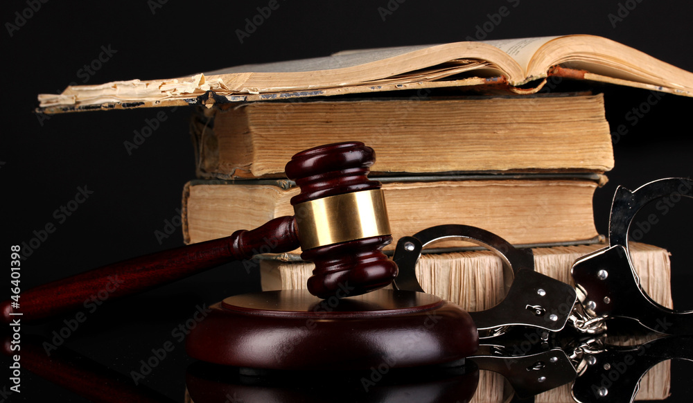 Gavel, handcuffs and.books on law isolated on black close-up Gavel, handcuffs and.books on law isolated on black close-up