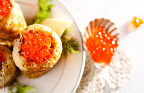 Snack with salmon caviar and pancakes photo