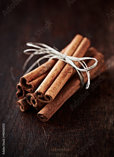 Cinnamon sticks on dark wooden background