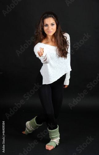 young modern dancer posing, isolated on black
