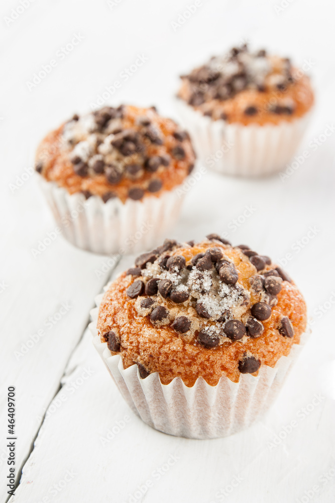 Chocolate chip muffins on white wood Chocolate chip muffins on white wood