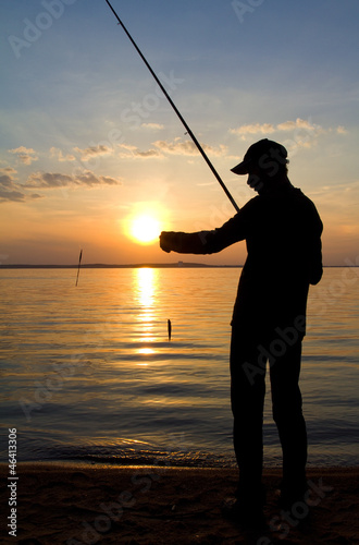 fisherman fishing on sunset