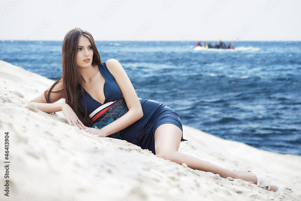 Woman in dress on the sea beach