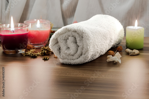 Towel, aromatic candles and other spa objects