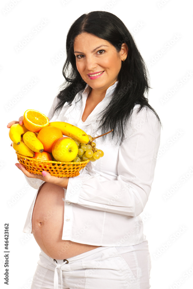 Pregnant holding full basket with fruits Pregnant holding full basket with fruits