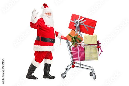 Santa Claus pushing a cart full of presents and waving hand © Ljupco Smokovski