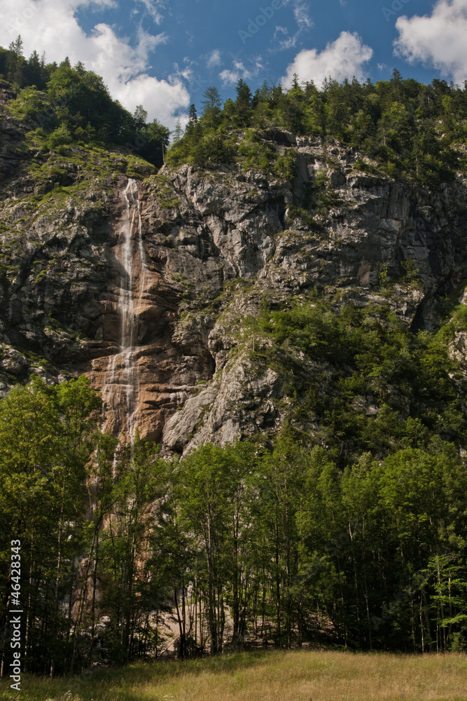 Waterfall falling from slope rocks