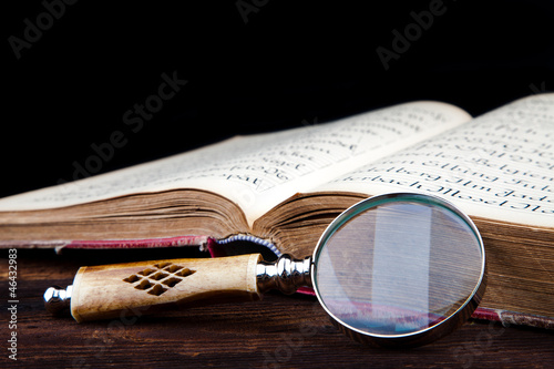 magnifying glass and old book
