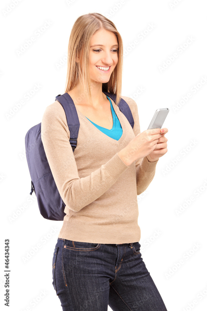 Smiling female typing a sms on her mobile phone Smiling female typing a sms on her mobile phone
