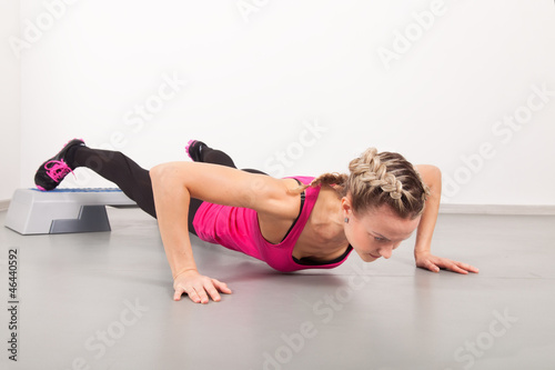 Athletic young woman doing exercises