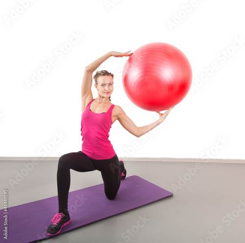 Athletic young woman with red ball