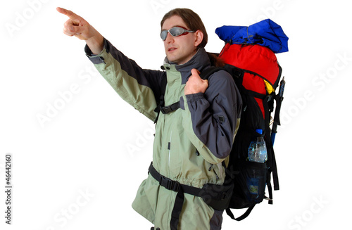 Hiker with tourist backpack is pointing on something - isolated 