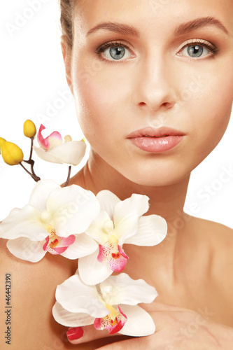 A young woman with orchid  isolated on white