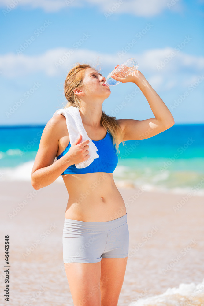 Beautiful Young Drinking Water after Beach Workout Beautiful Young Drinking Water after Beach Workout